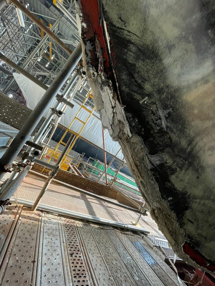 Damaged and delaminated GRP on the bow of M/Y Kahala before repair